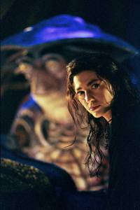Claudia Black is Ex-Peacekeeper Aeryn Sun, with Henson creation “Pilot” in the background